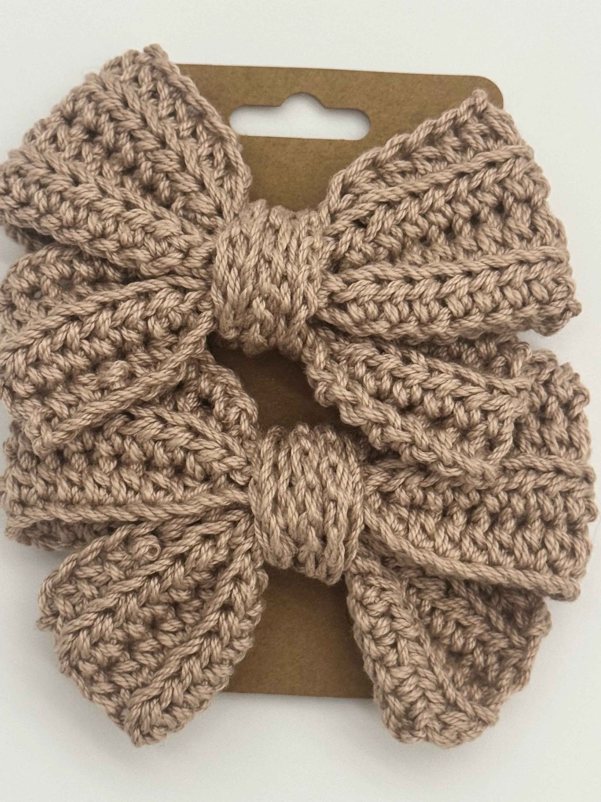 Handcrafted crochet bow hair accessory by C2 Creations LLC, featuring a colorful, textured design for stylish hair decoration.