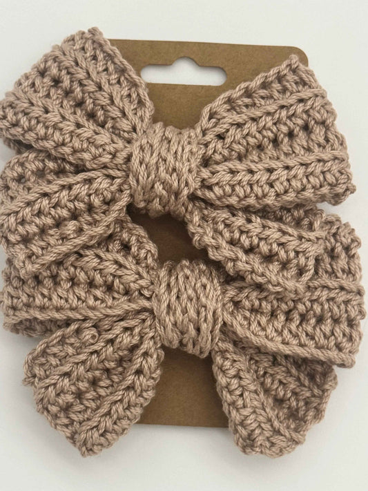 Handcrafted crochet bow hair accessory in soft pastel colors, designed by C2 Creations LLC, perfect for stylish hair decor.