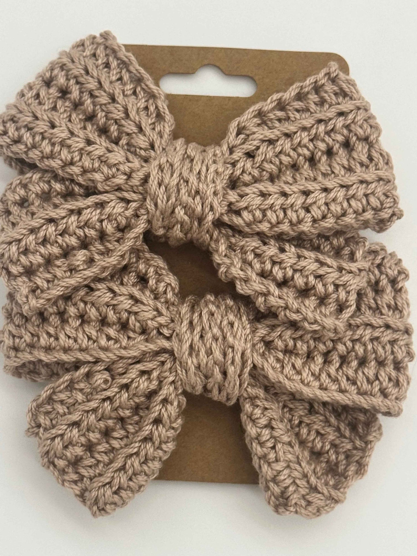 Handcrafted crochet bow hair accessory by C2 Creations LLC, featuring a colorful, textured crochet design for stylish hair decor.