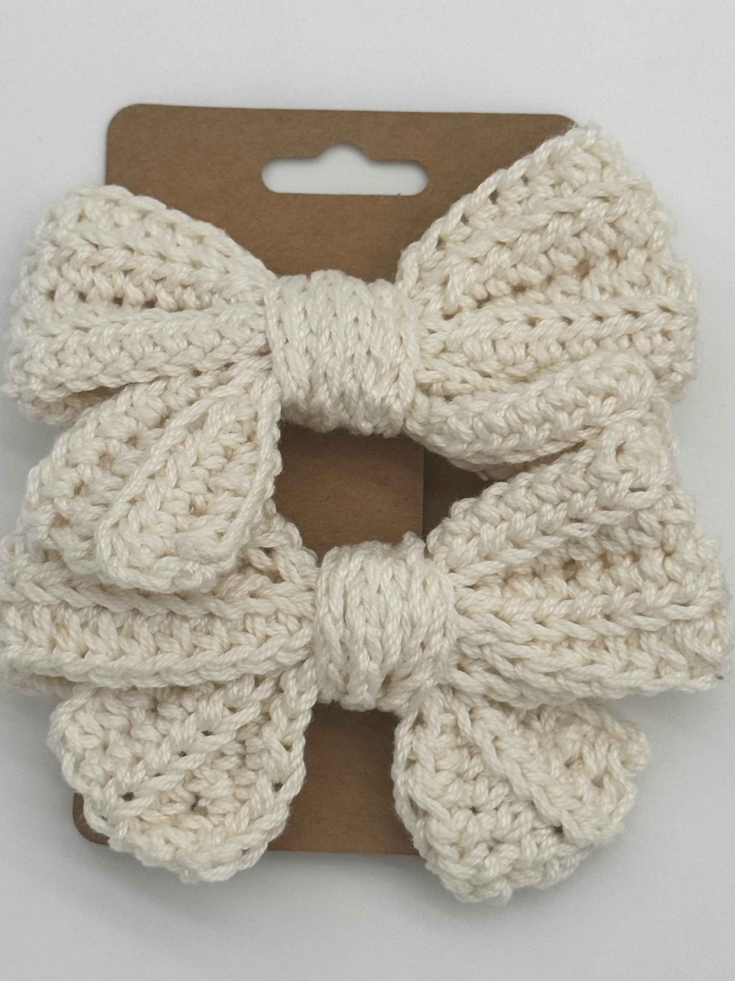 Handcrafted crochet bow hair accessory by C2 Creations LLC, featuring a colorful, textured design for stylish hair decoration.