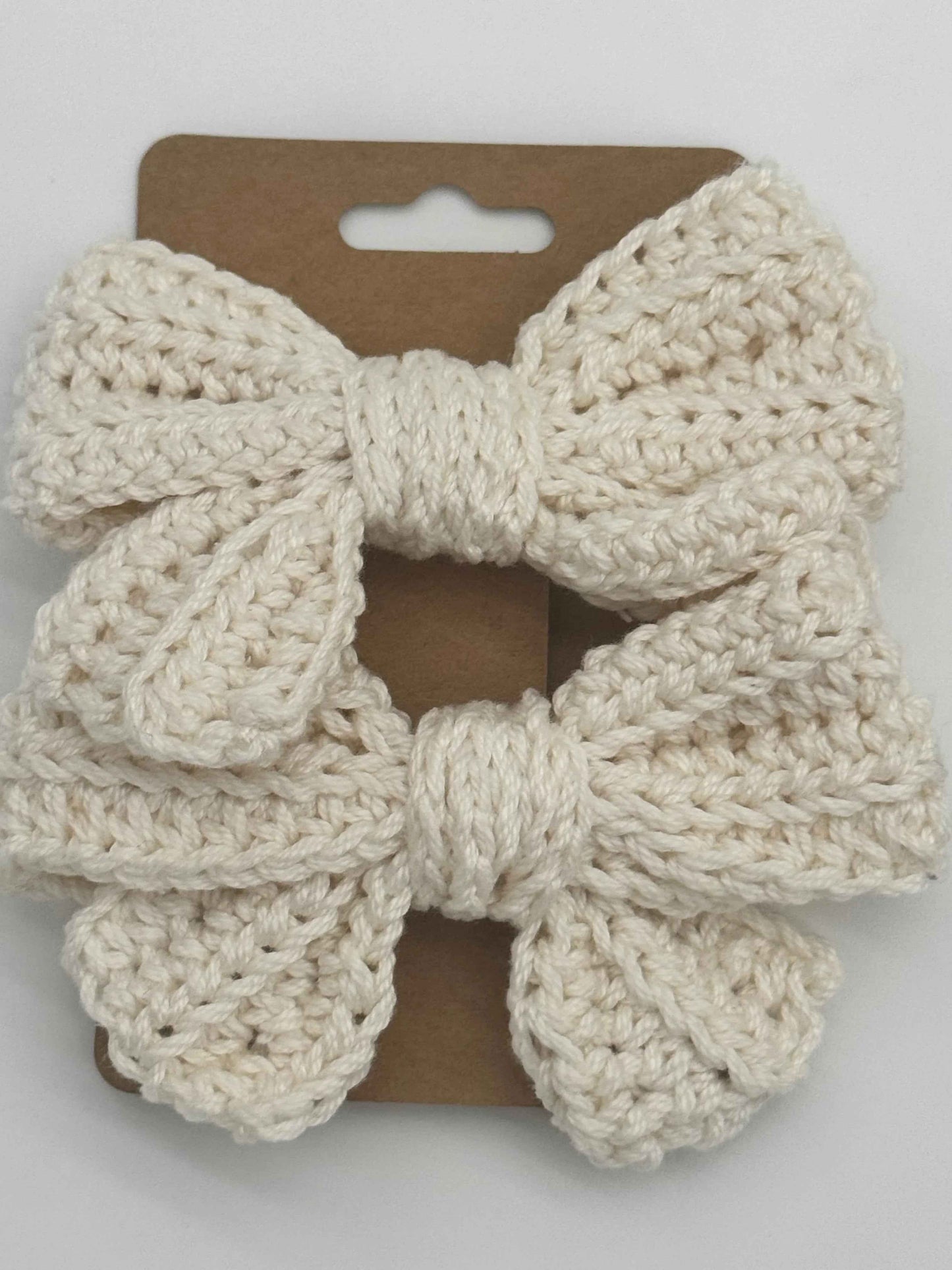 Handcrafted crochet bow hair accessory by C2 Creations LLC featuring a colorful, textured design for stylish hair decoration.