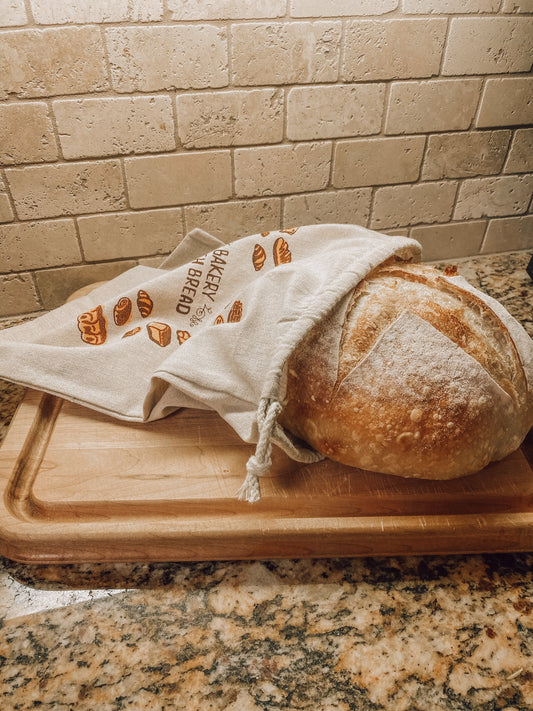 Onic Brands LLC bread bag for storing baked goods, made of durable fabric with a drawstring closure.