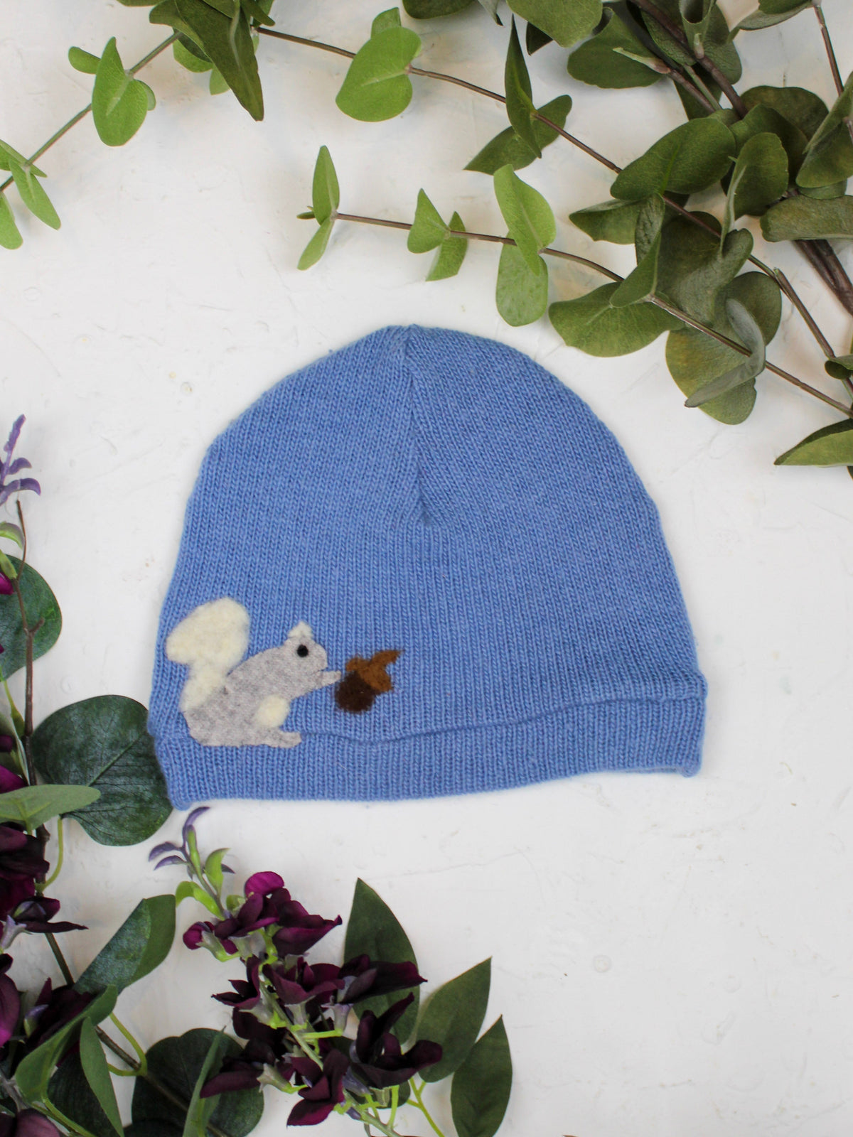 Child's Squirrel Cashmere Hat by Ash & Rose, cozy pink knit hat with squirrel design, perfect for warm winter wear.