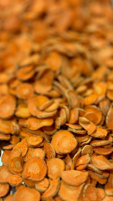 Organic freeze-dried carrot dog treats from Bear's Bites, showing a close-up of the crunchy, natural pet treat with carrot pieces.