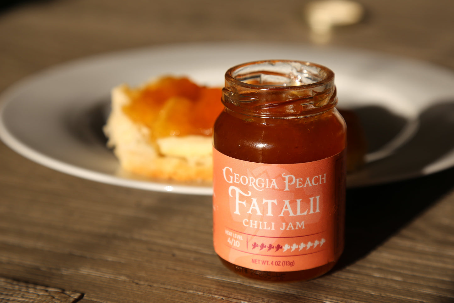 Peach Fatalii jam jar from Powerful Pepper Company, showcasing vibrant peach-colored jelly with a rustic label.