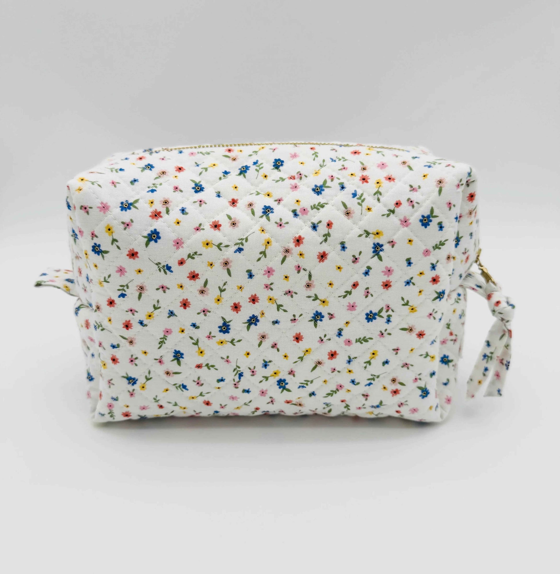 Handmade boxy makeup bag by C2 Creations LLC with wildflower meadow pattern, stylish toiletry storage with floral design.