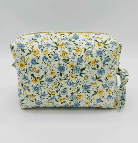 Handmade floral makeup bag by C2 Creations LLC with blue and yellow garden pattern, featuring a toiletry bag design.