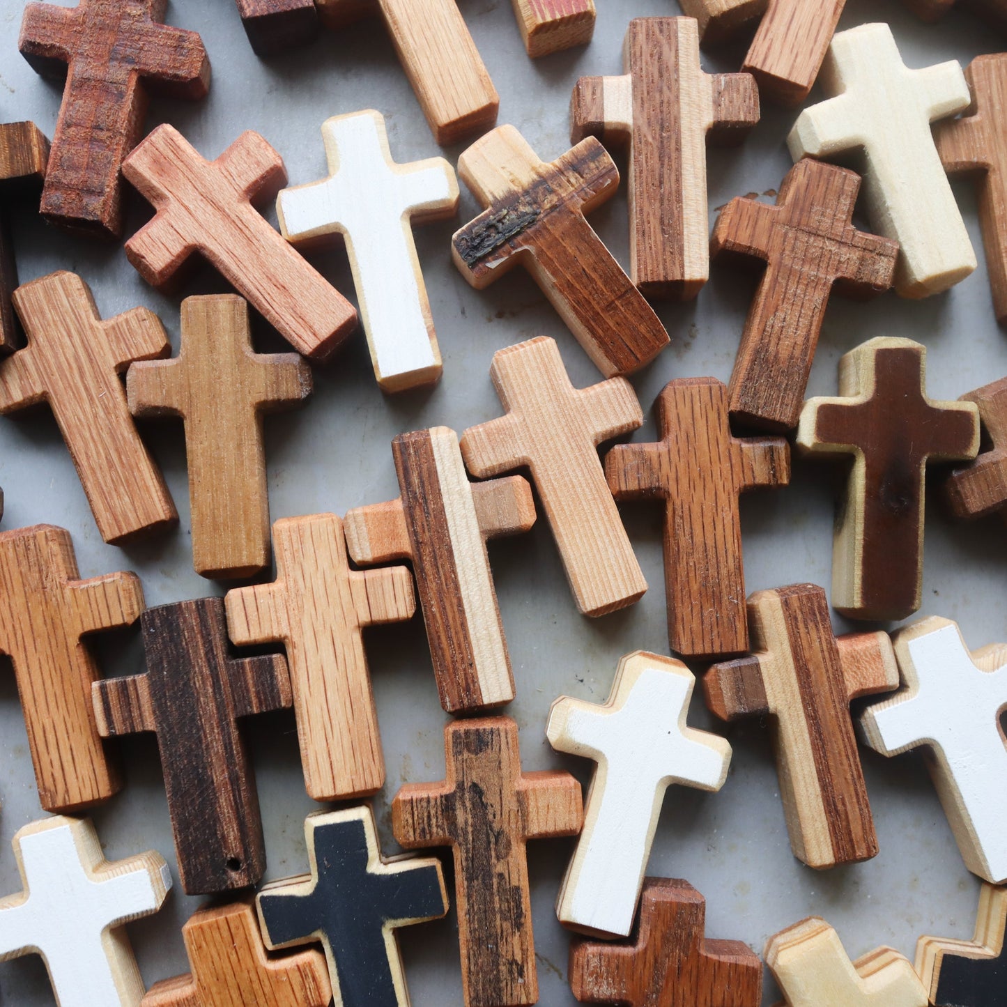 Handmade wooden pocket crosses by Dennehey Design Co. featuring detailed craftsmanship and natural wood finish.