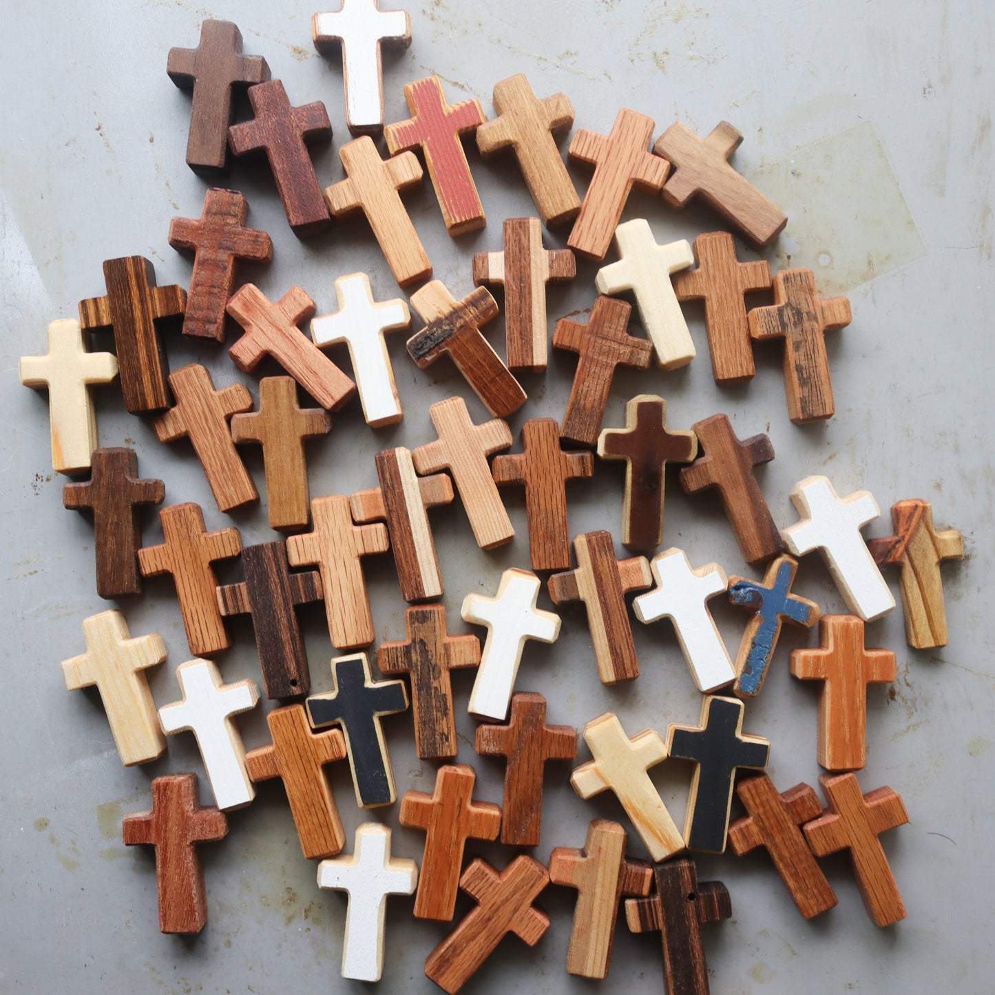 Handmade wooden pocket cross from Dennehey Design Co. featuring intricate carved details on a small, natural wood cross.