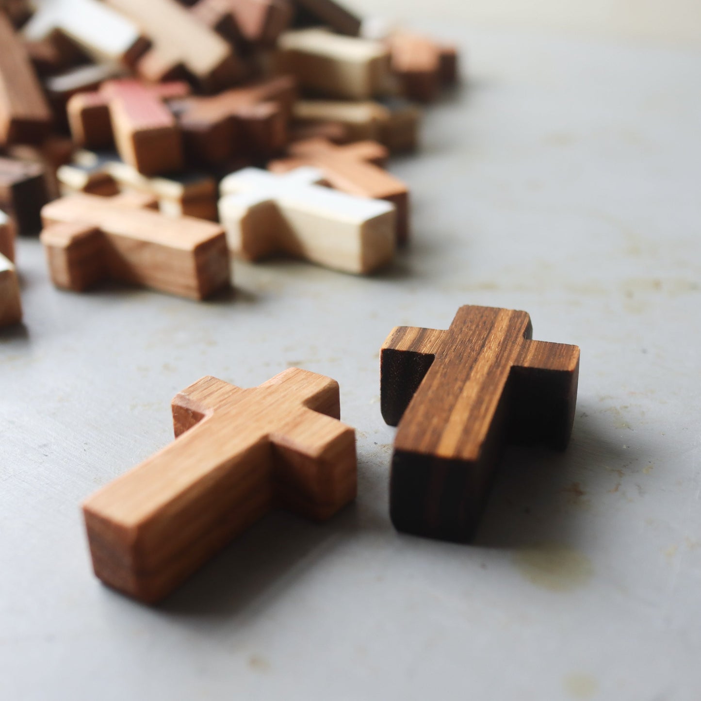 Handmade wooden pocket cross by Dennehey Design Co., featuring a detailed, natural wood finish and compact size for personal use.