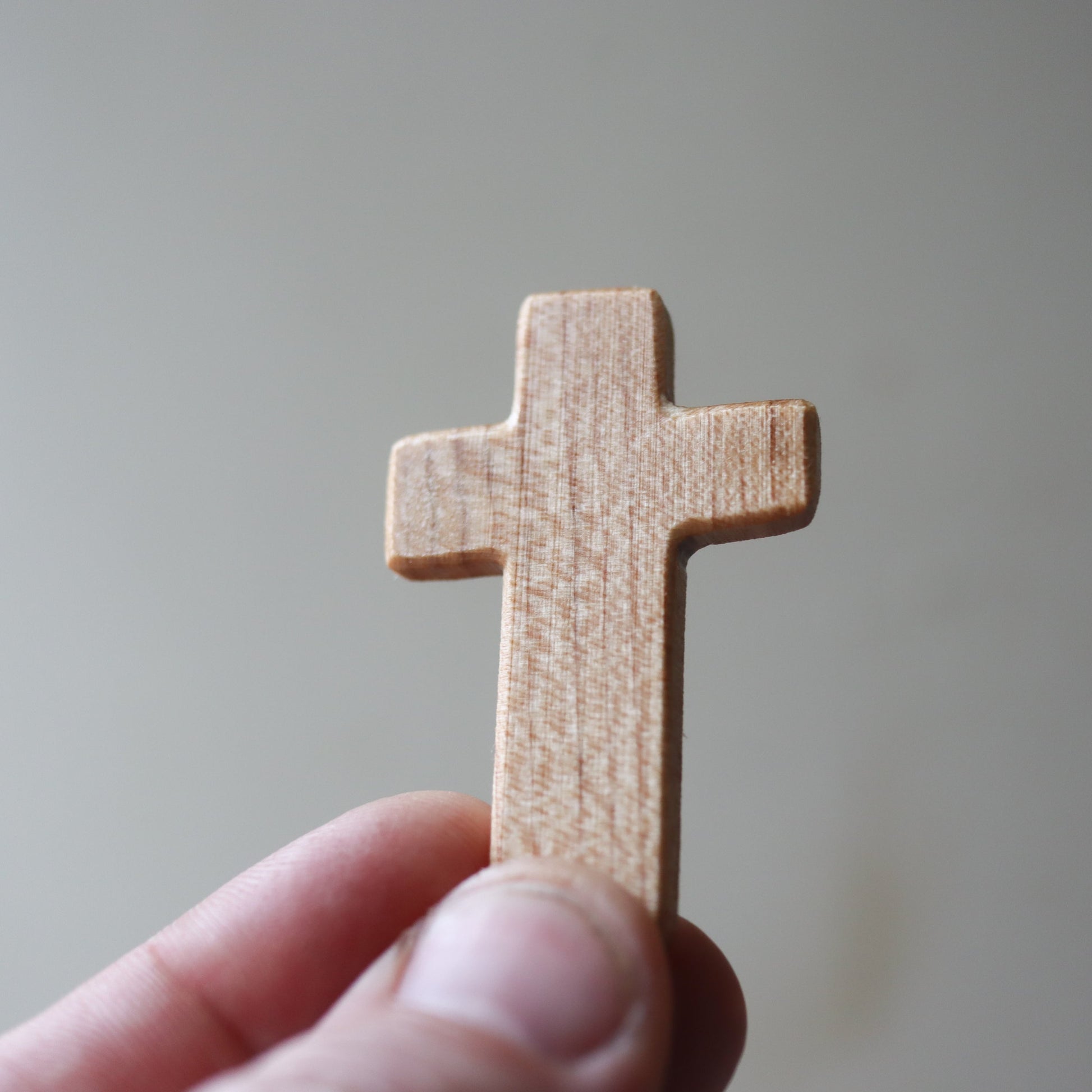 Wooden Thin Pocket Cross by Dennehey Design Co. featuring a sleek, lightweight cross design perfect for carrying or gifting.