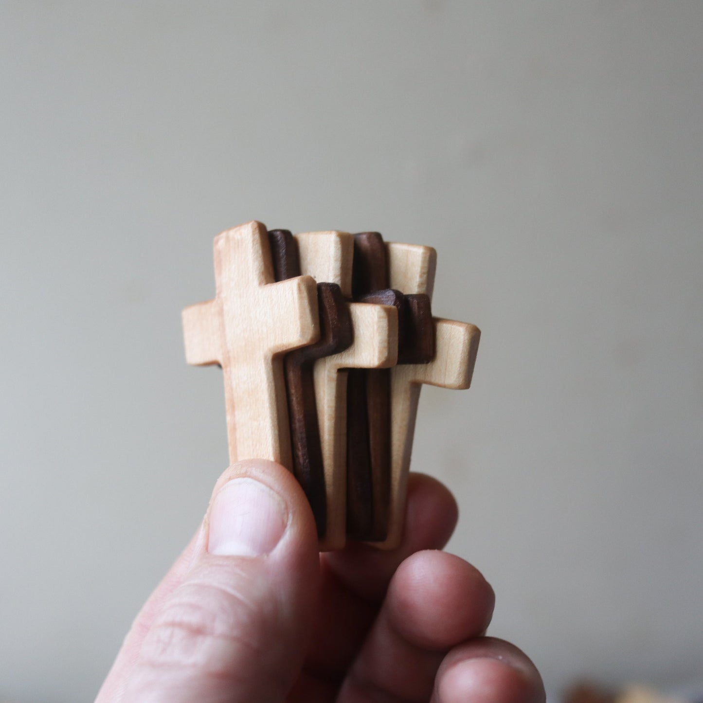 Wooden cross with thin pocket design by Dennehey Design Co., displayed on a neutral background.