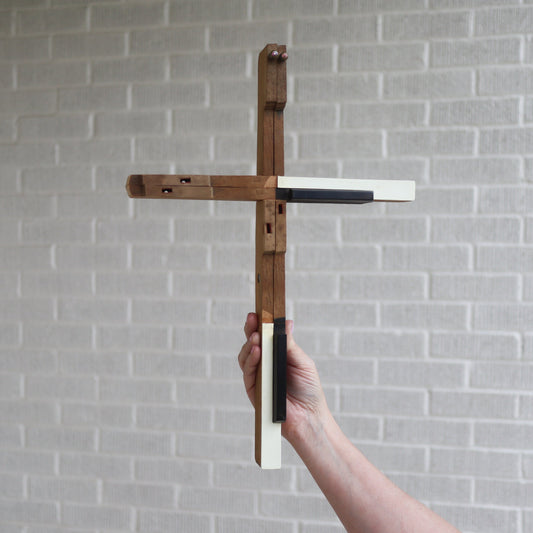 Wooden piano key cross by Dennehey Design Co., crafted from light-colored wood with detailed piano key design.