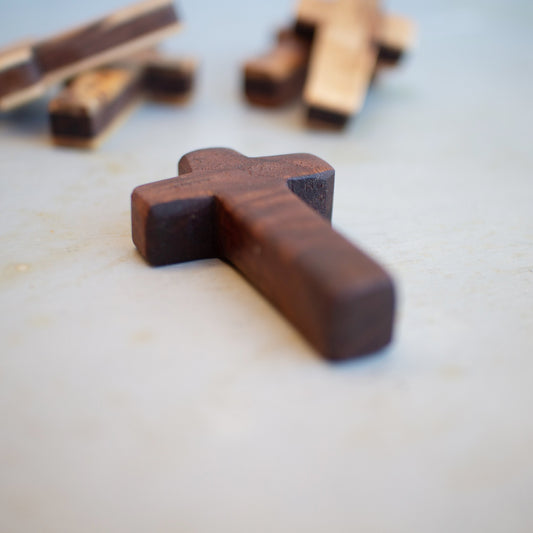 Handmade wooden pocket crosses by Dennehey Design Co., small wooden crosses suitable for personal or spiritual use.