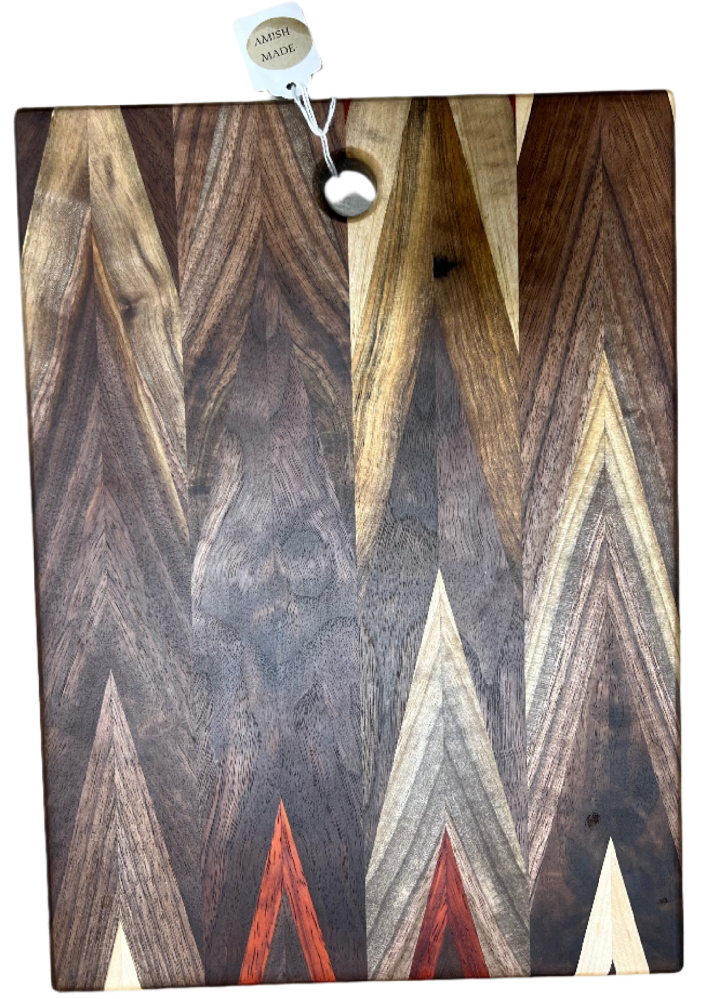 Handcrafted Amish Chevron cutting board made of multi-wood inlay with beeswax finish, measuring 9.5 by 14 inches, on a kitchen countertop.