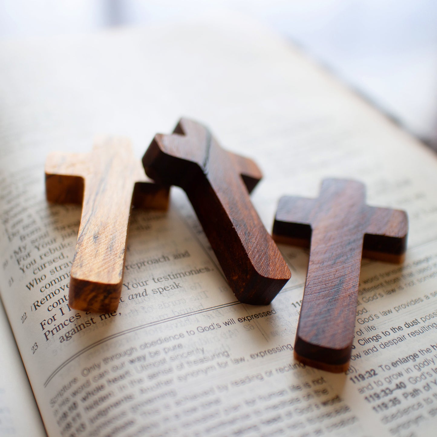 Handmade wooden pocket cross by Dennehey Design Co. featuring a detailed, natural wood finish and compact size for personal use.