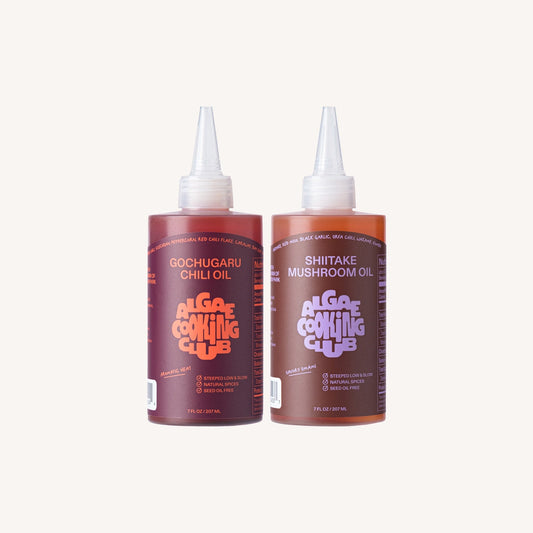 Algae Cooking Club infused oil duo featuring two bottles of flavorful, natural cooking oils in clear glass bottles.