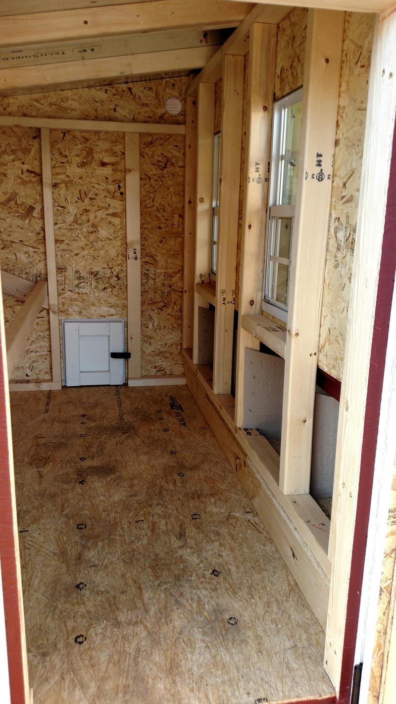 Inside view of a large OverEZ chicken coop designed for up to 15 chickens, showing spacious interior and nesting areas.