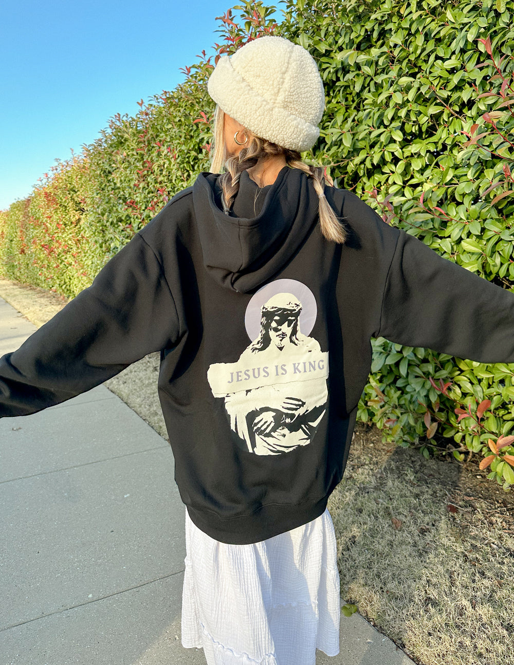 Black unisex hoodie featuring Jesus Is King design by Elevated Faith, with bold graphic artwork on the front.