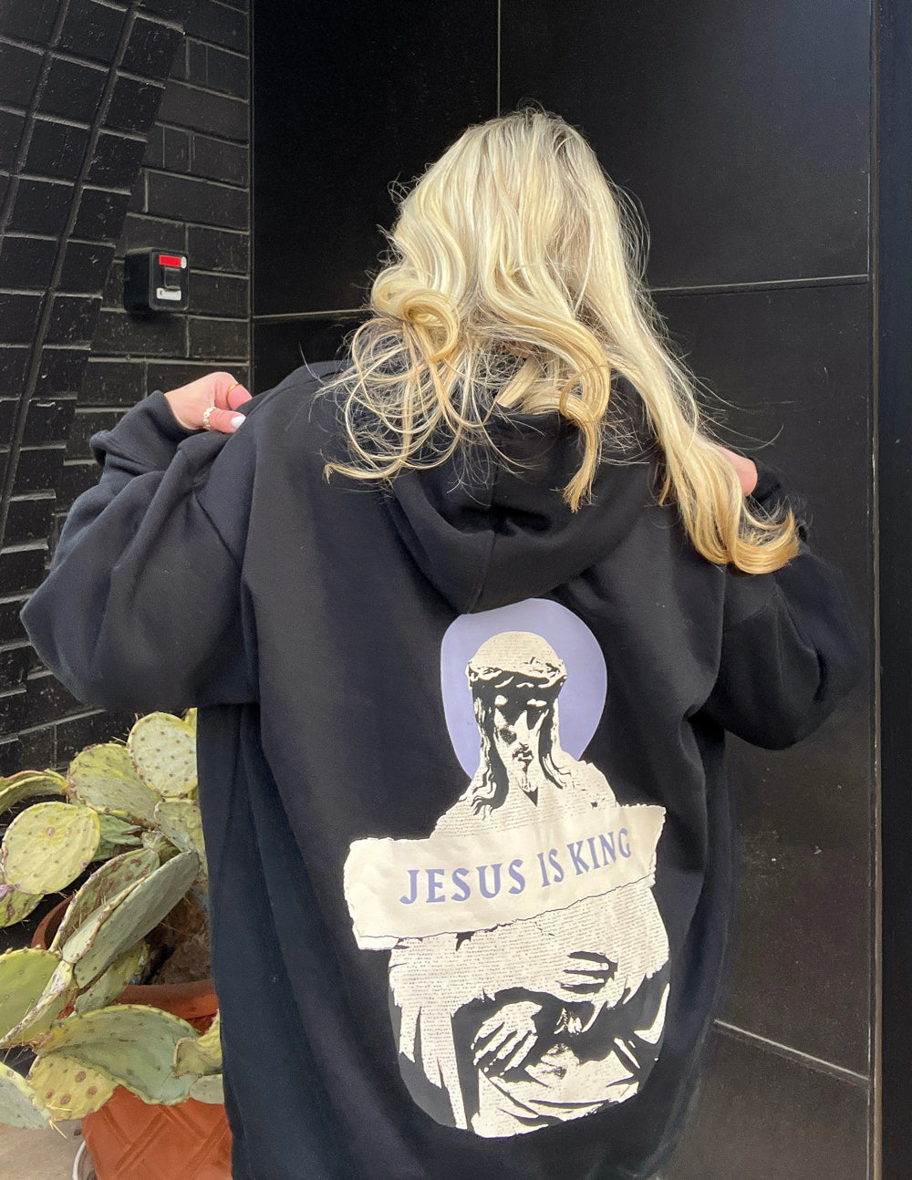 Black unisex hoodie featuring religious artwork from Elevated Faith's Jesus Is King collection, made of soft cotton fabric.
