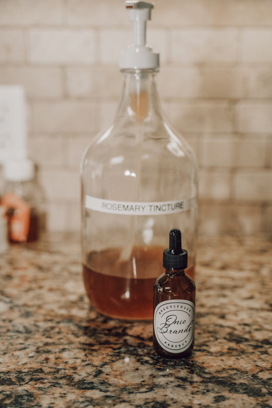 Onic Brands Elemental Rosemary Tincture bottle with rosemary sprigs and dropper, natural herbal supplement for wellness.