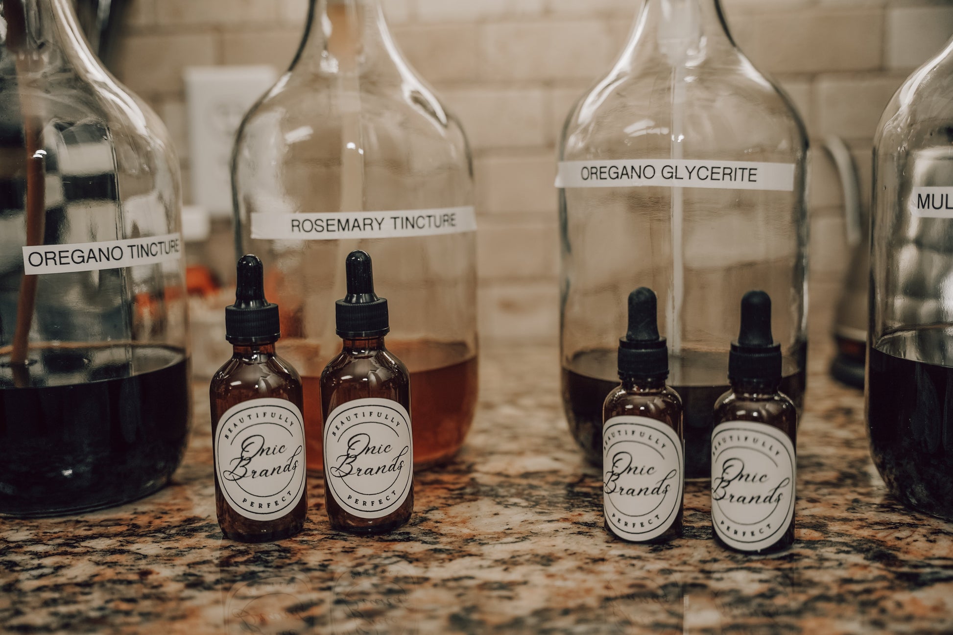 Bottle of Onic Brands Elemental Oregano Tincture with dropper cap, labeled with product details and brand logo.