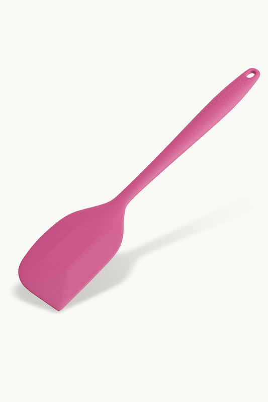 Lynnee baking spatula in hot pink, flexible silicone spatula for mixing and scraping in kitchen baking tasks.
