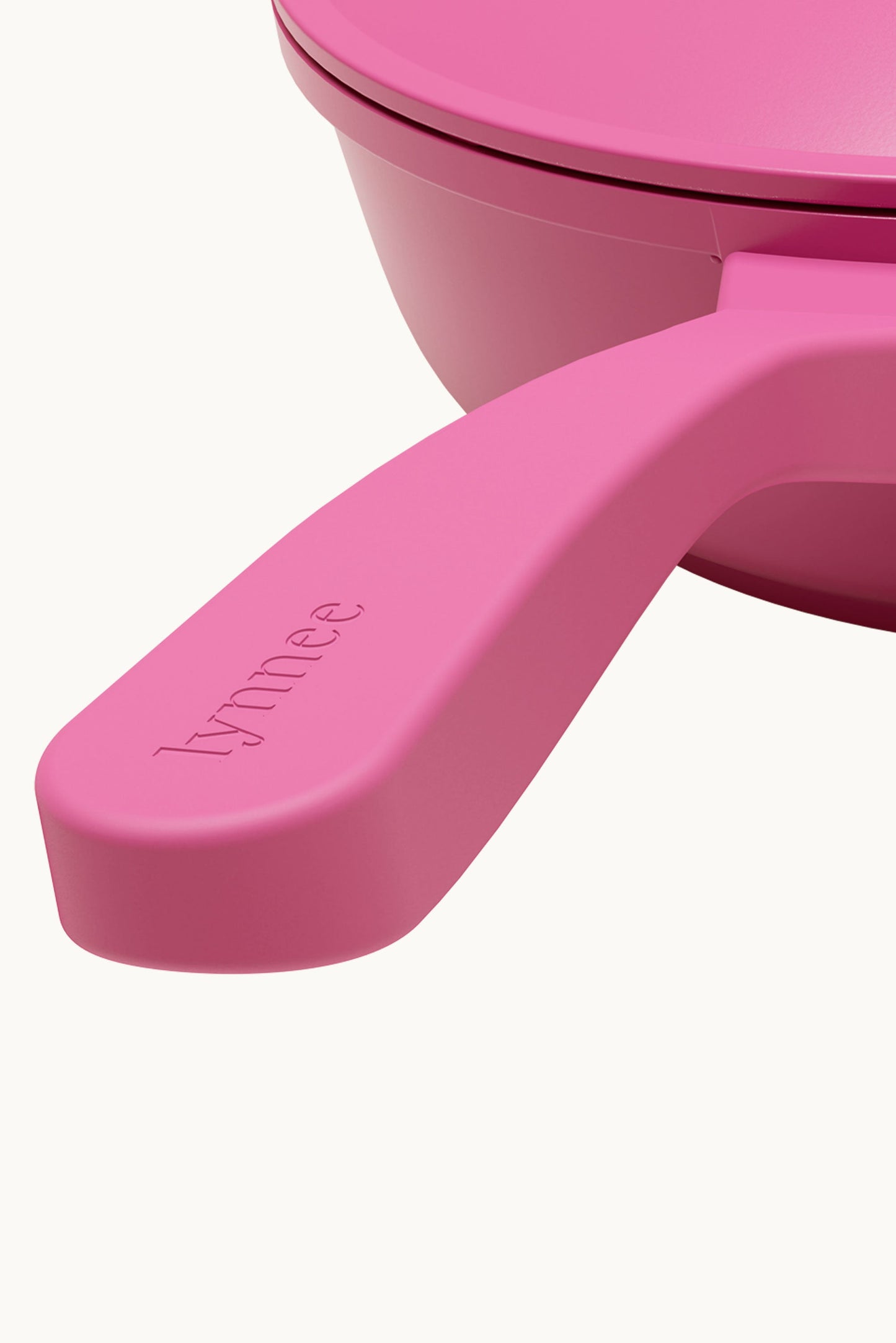Pink 11-inch Lynnee frying pan with non-stick surface and ergonomic handle, ideal for versatile cooking.