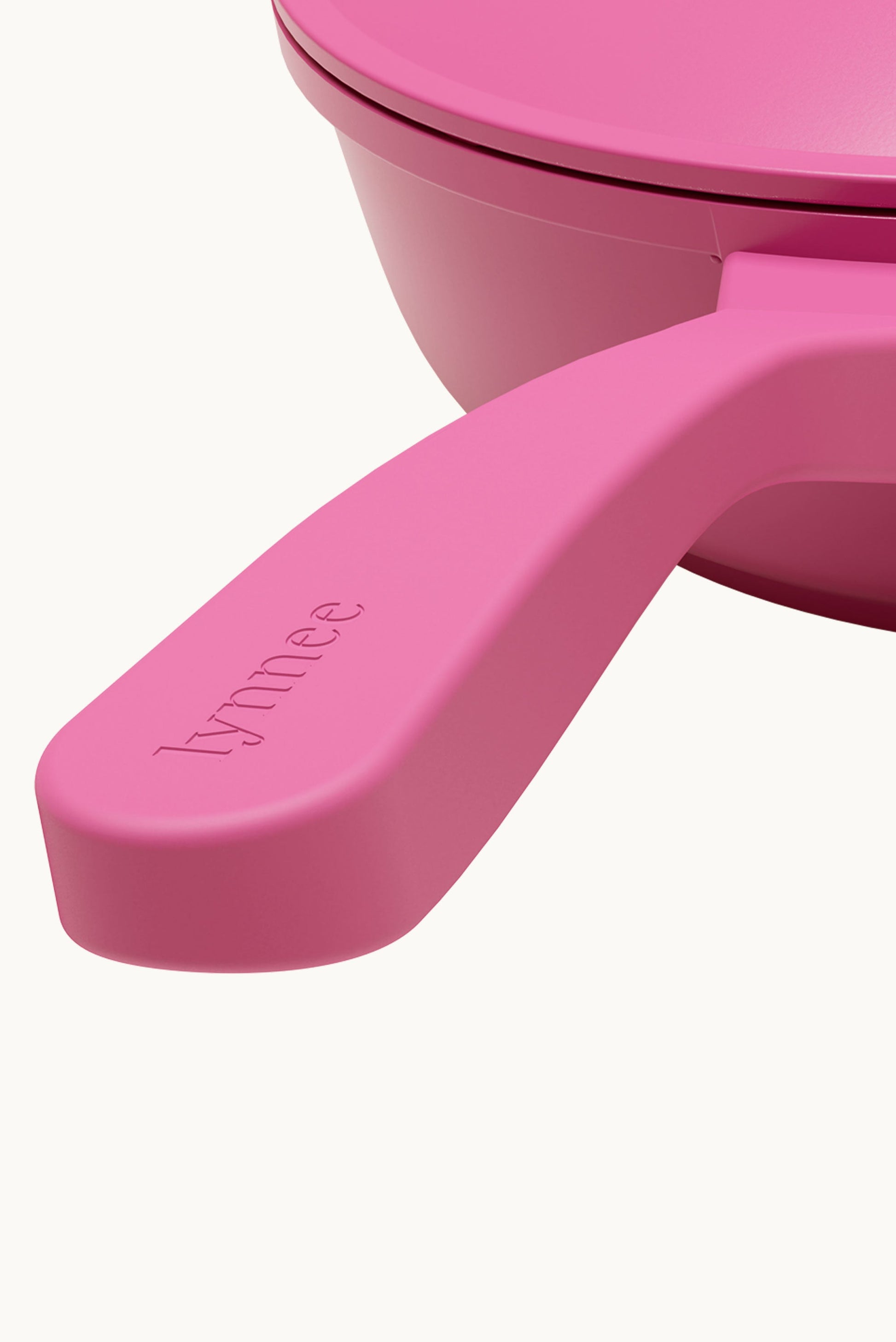 Pink 11-inch Lynnee frying pan with non-stick surface and ergonomic handle, ideal for versatile cooking.