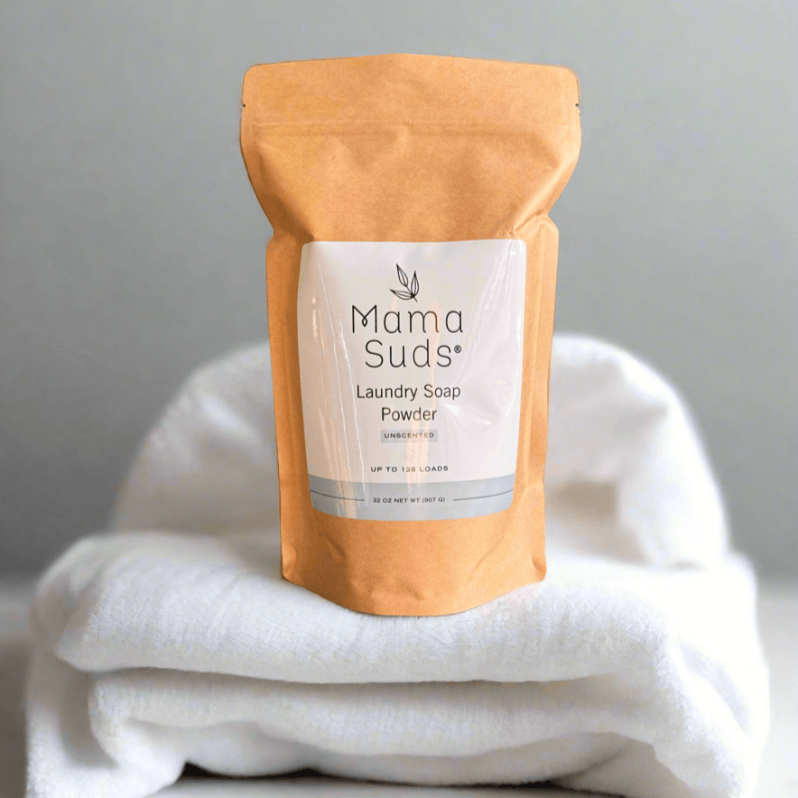 MamaSuds laundry soap powder in a white container, household cleaning product for fresh, clean laundry.