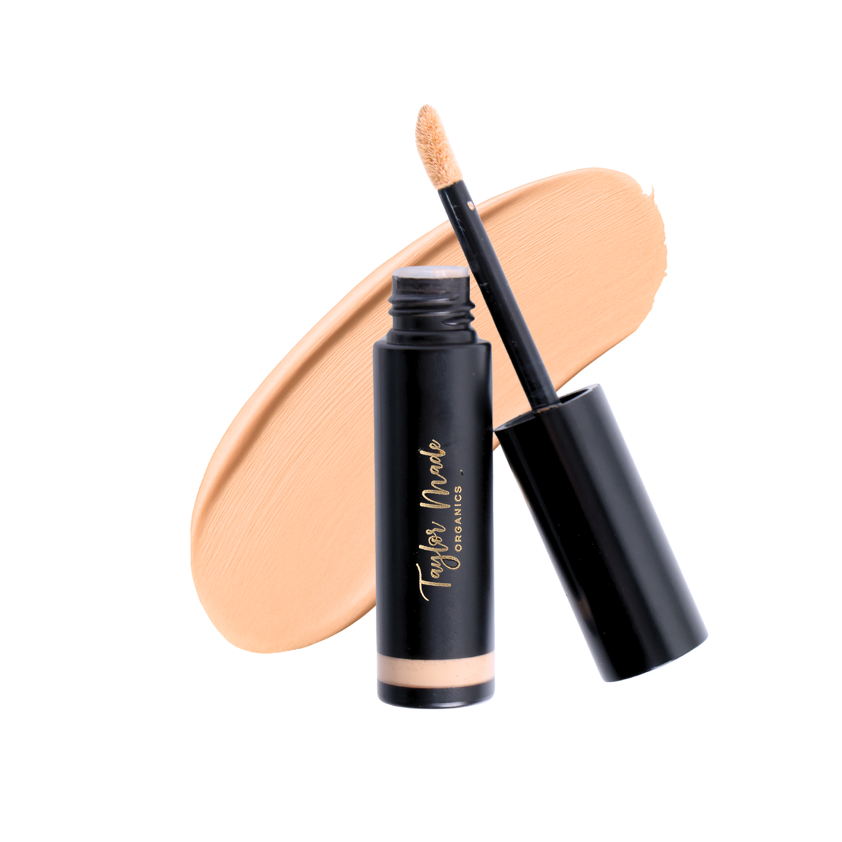 Taylor Made Organics linen liquid concealer smear showing smooth, lightweight formula for natural coverage on skin.