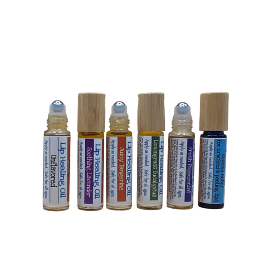 Group of By Robin Creations lip repair healing oils, nourishing lip balms in sleek containers with natural ingredients.