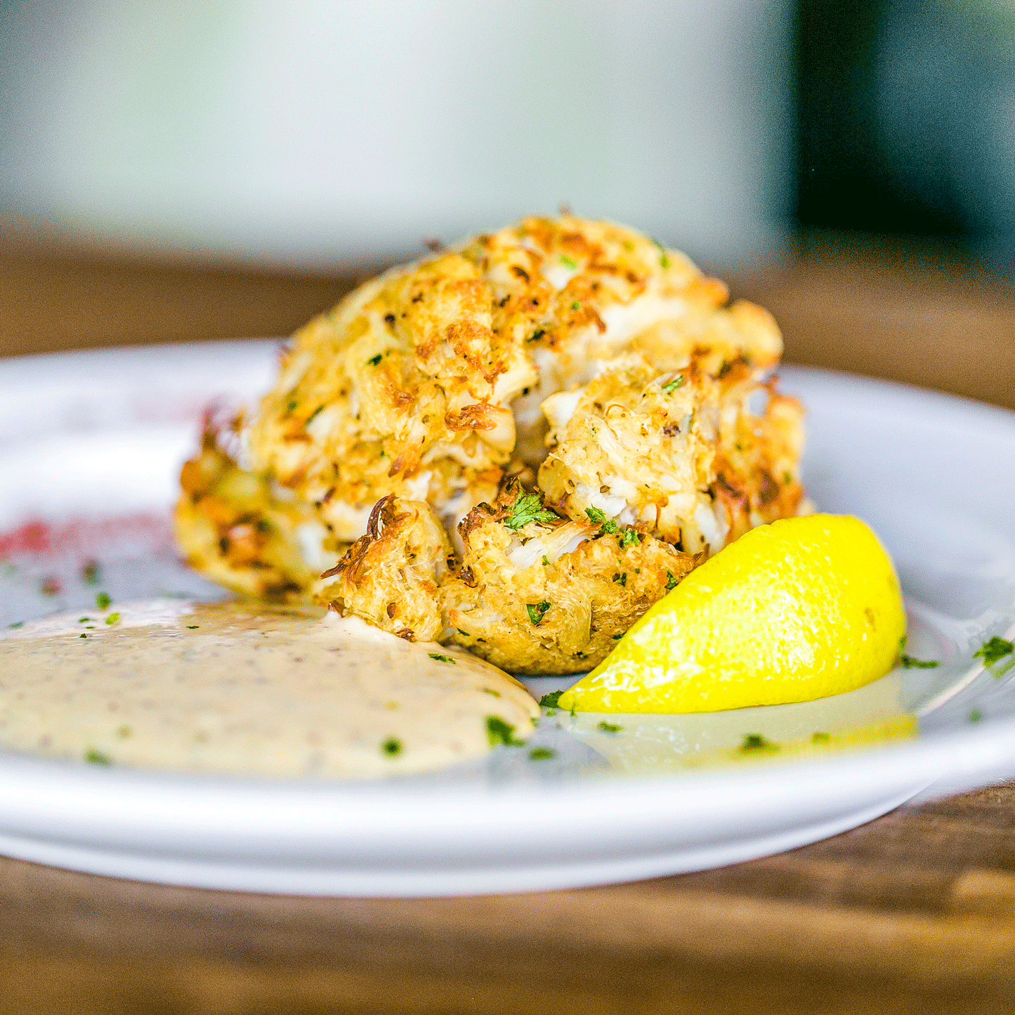 Jumbo lump crab cakes from Pig of the Month BBQ, showing golden-brown crab cake with crispy exterior and flaky crab meat inside.