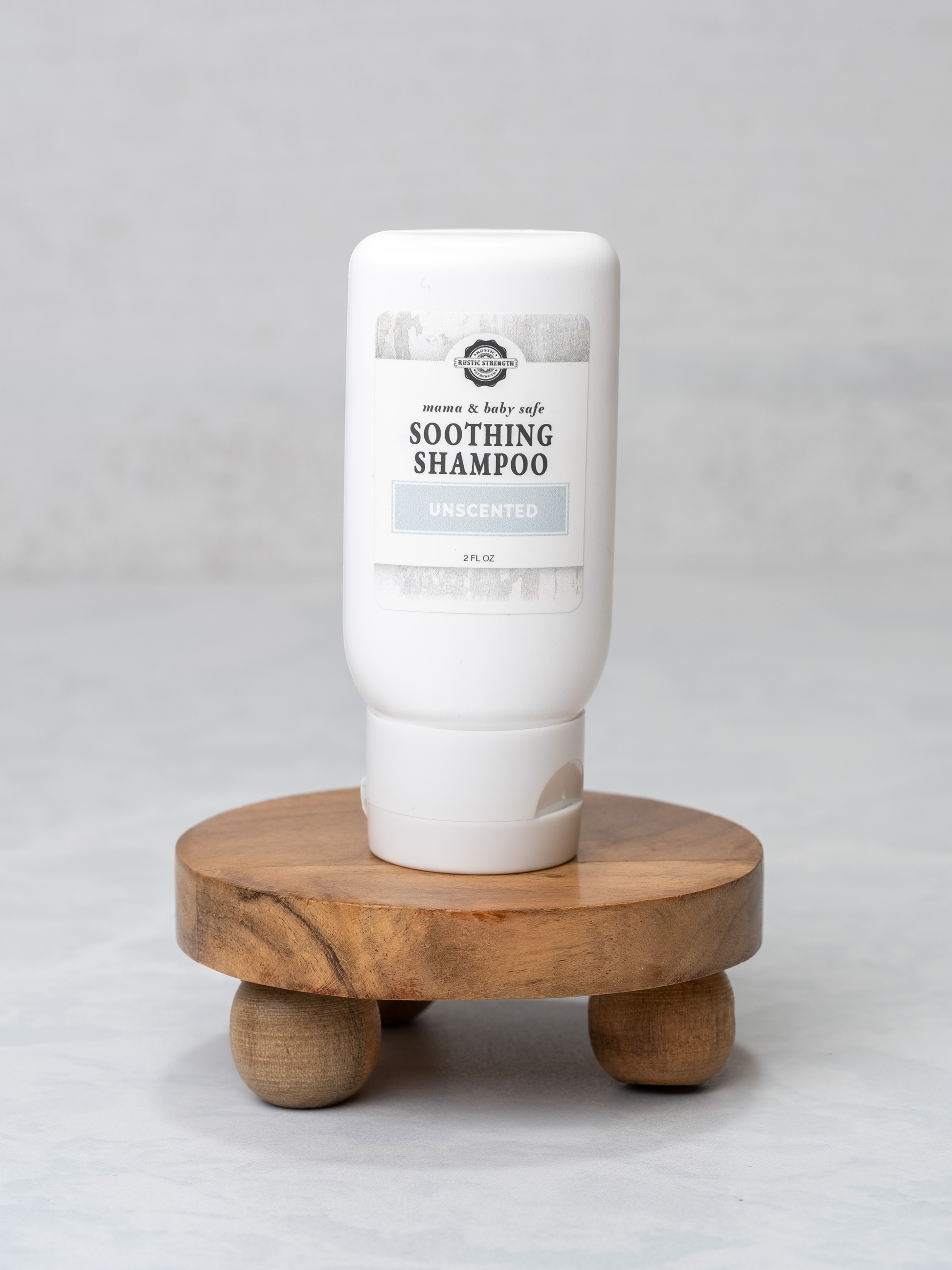 Rustic Strength Mama + Baby travel kit with 2 oz shampoo bottles, featuring natural bath and body products for gentle care.