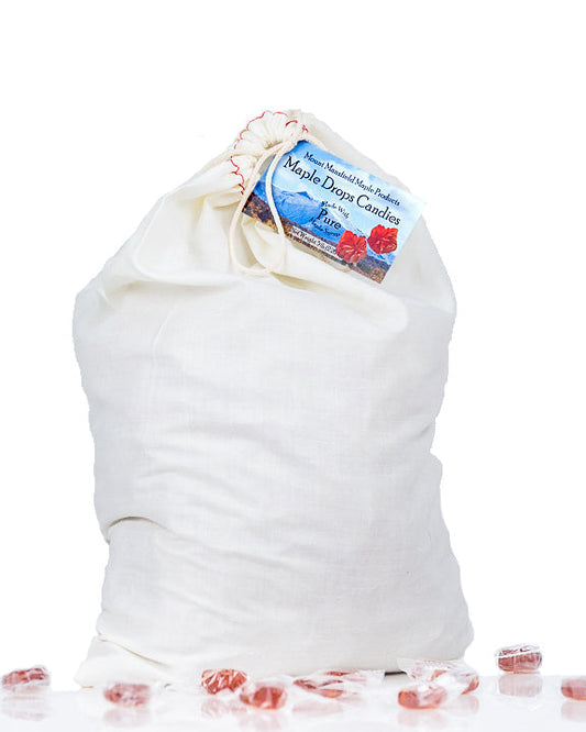 Assorted Mount Mansfield Maple Drops Hard Candy in a clear bag, showcasing shiny, golden maple candy pieces.
