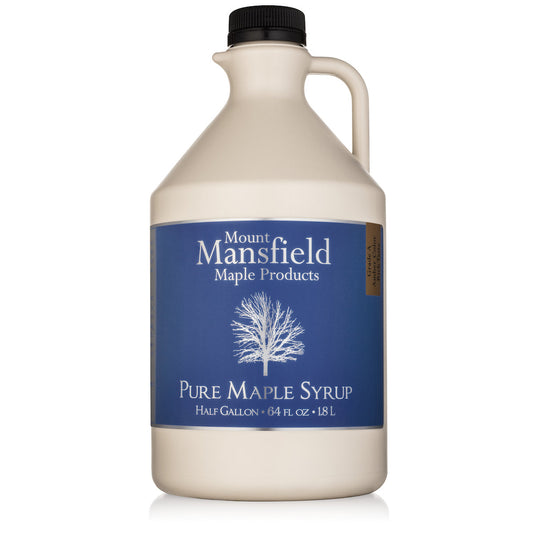 Half-gallon plastic jug of Mount Mansfield Maple Products Pure Vermont Maple Syrup with a clear label and orange cap.