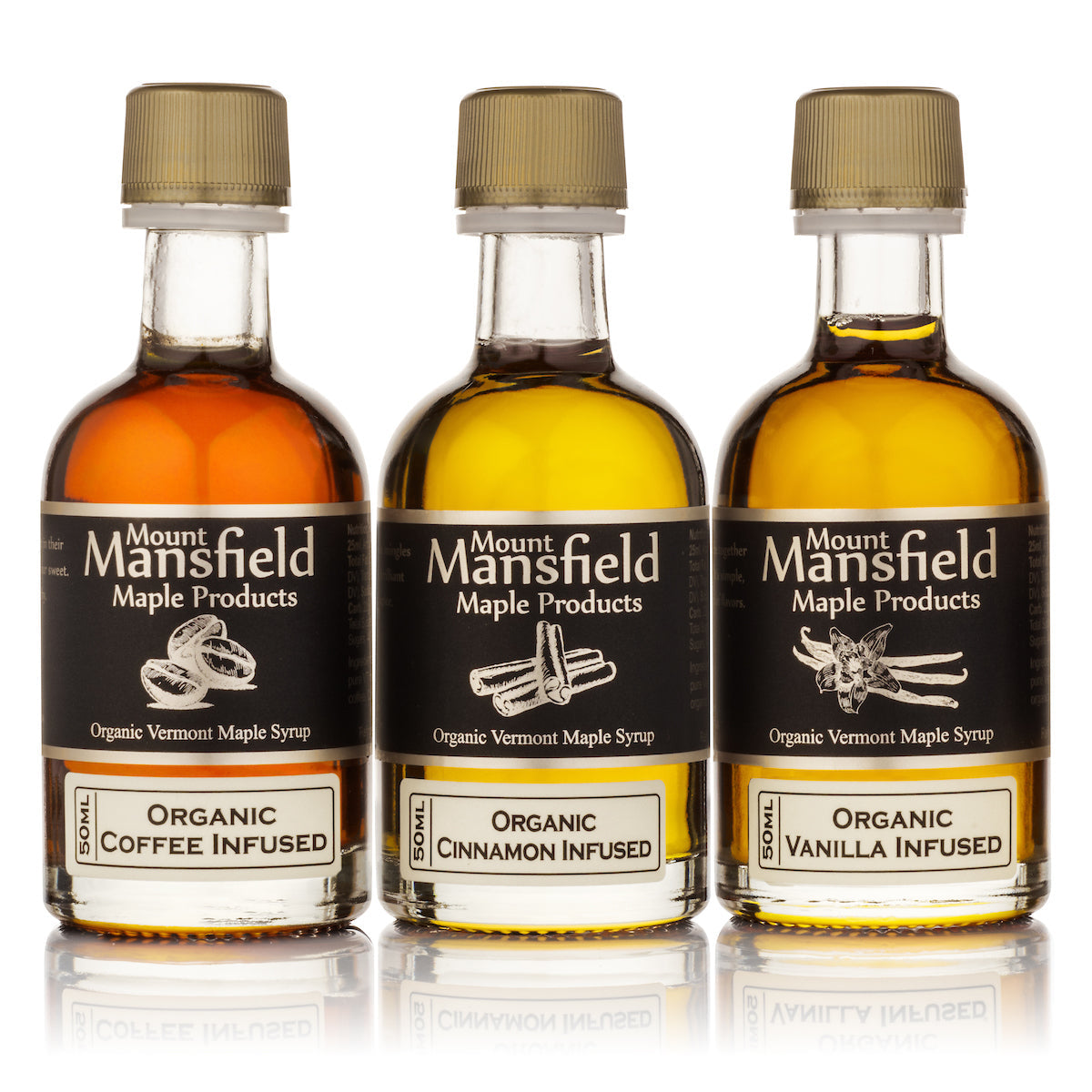 Three bottles of Mount Mansfield Maple Products infused Vermont maple syrup in a sampler set, showcasing the different infused flavors.