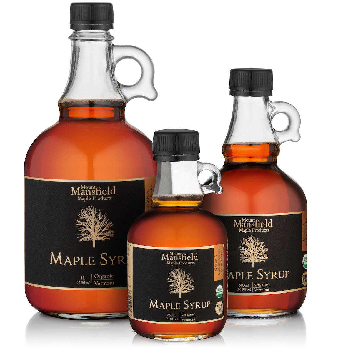Organic Vermont maple syrup in a glass jug by Mount Mansfield Maple Products, showcasing rich, golden syrup inside a clear bottle.
