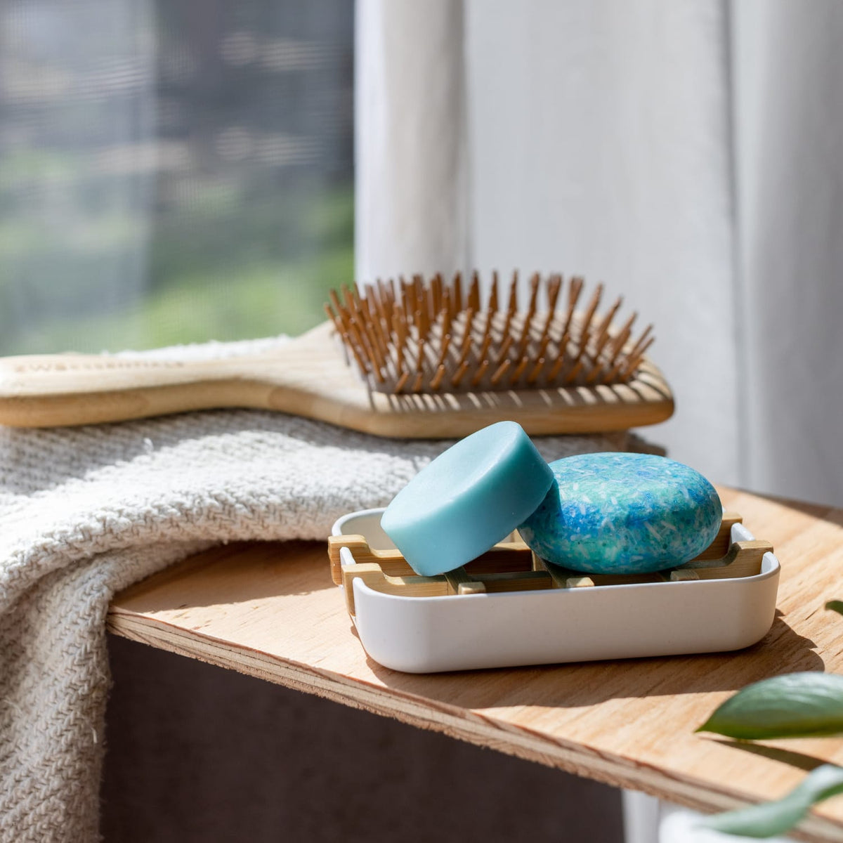 Bamboo soap dish from ZeroWasteStore.com with a natural wood finish, designed to hold soap bars and keep them dry.