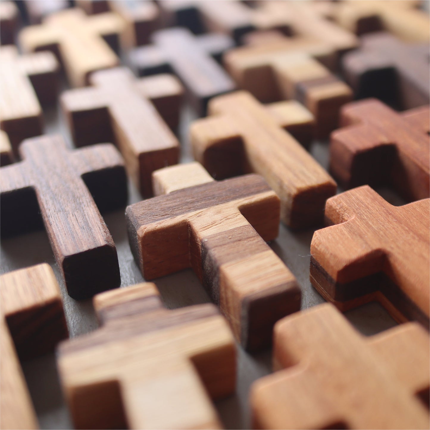 Handmade wooden pocket crosses by Dennehey Design Co., featuring detailed craftsmanship and natural wood finish.