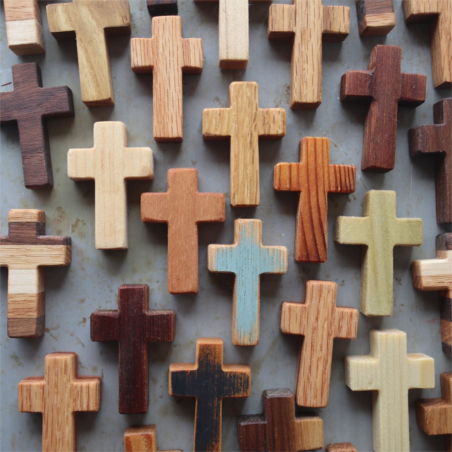Handmade wooden pocket cross by Dennehey Design Co. featuring a finely crafted wooden cross with detailed natural wood grain.