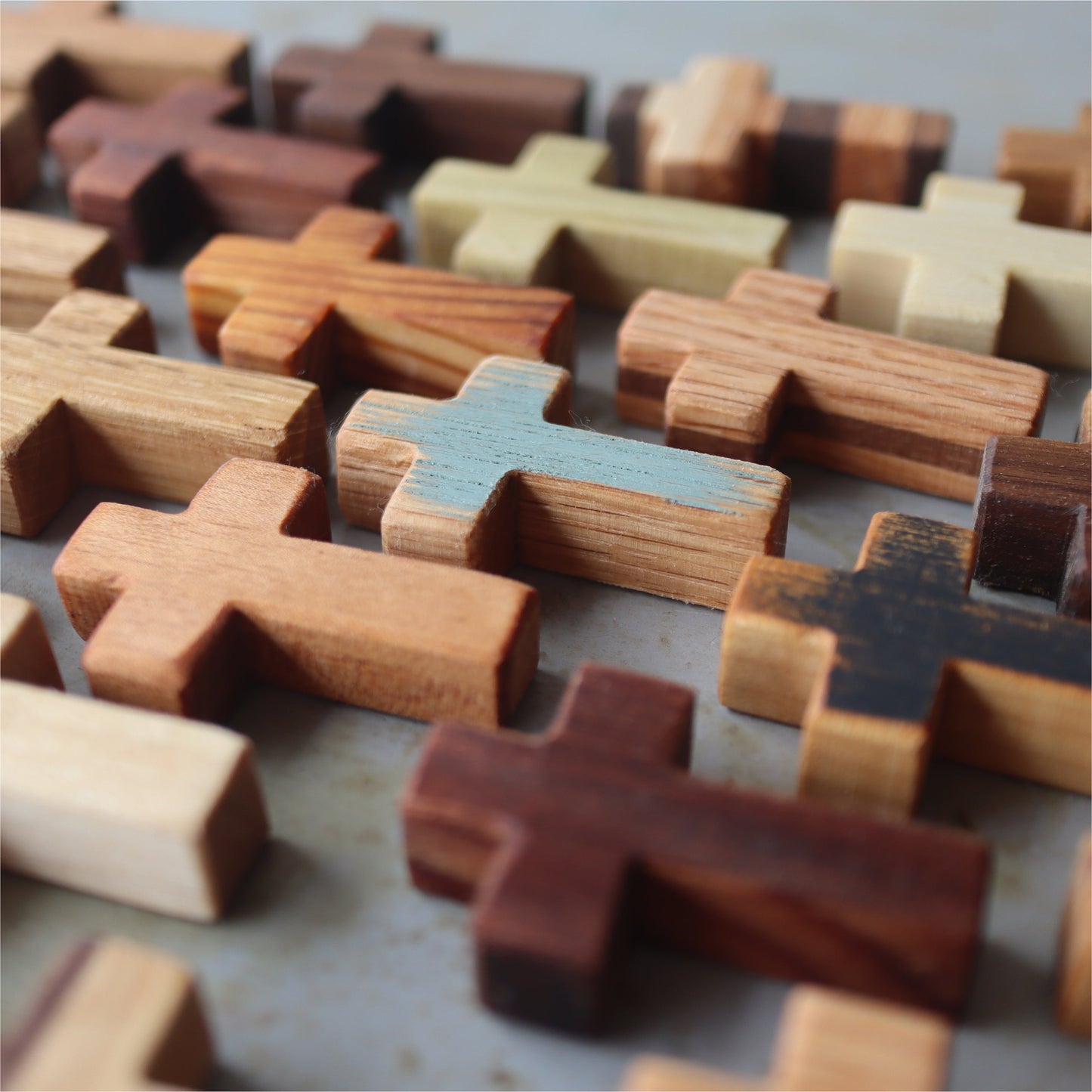 Handmade wooden pocket cross from Dennehey Design Co., featuring a natural finish and compact size for personal faith reflection.