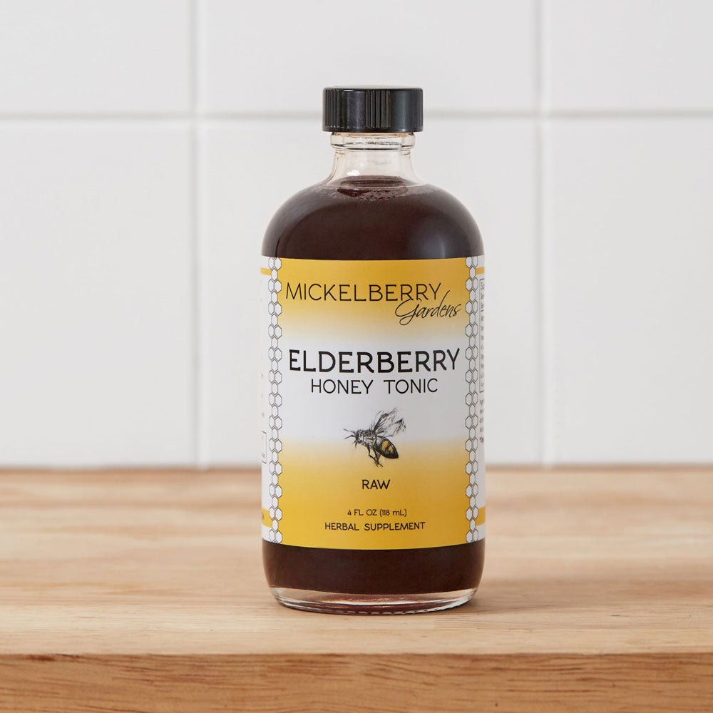 4oz bottle of Mickelberry Gardens Elderberry Honey Tonic featuring a honey and elderberry blend in a glass bottle.