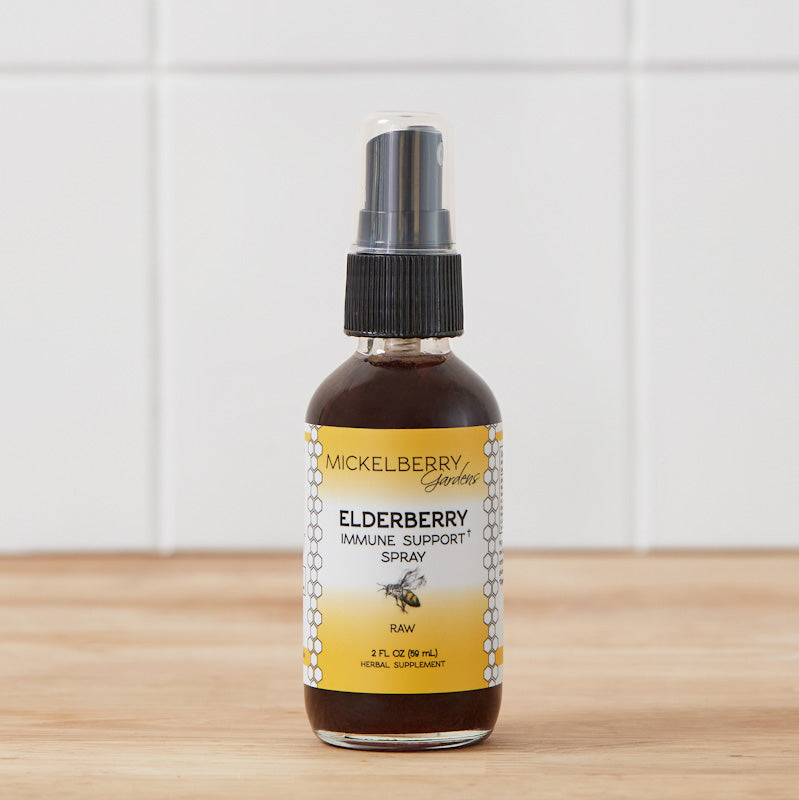 Mickelberry Gardens elderberry immune support honey tonic spray in a 2oz bottle, with natural elderberries and honey ingredients visible.