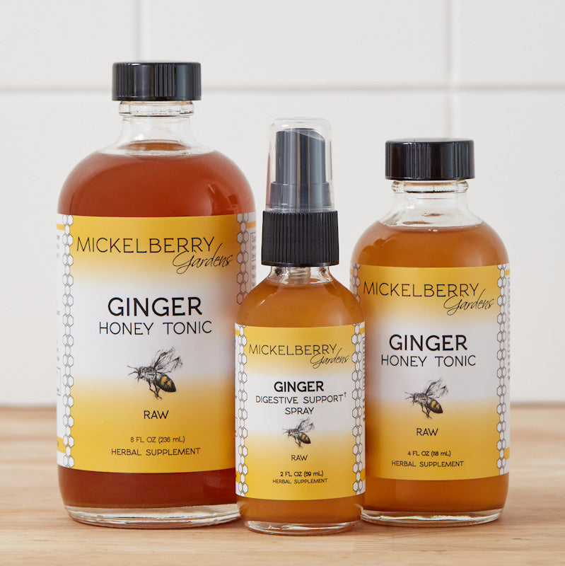 Mickelberry Gardens Ginger Honey Tonic spray bottle, herbal honey tonic for wellness, displayed on a wooden surface.