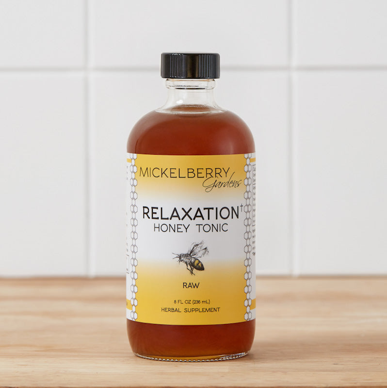8oz bottle of Mickelberry Gardens Relaxation Honey Tonic with golden honey and herbal ingredients in a clear glass bottle.
