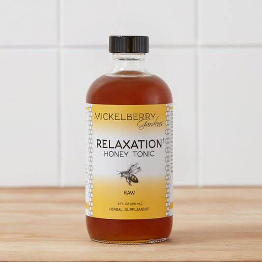 8oz bottle of Mickelberry Gardens Relaxation Honey Tonic with golden honey and herbal ingredients in a clear glass bottle.