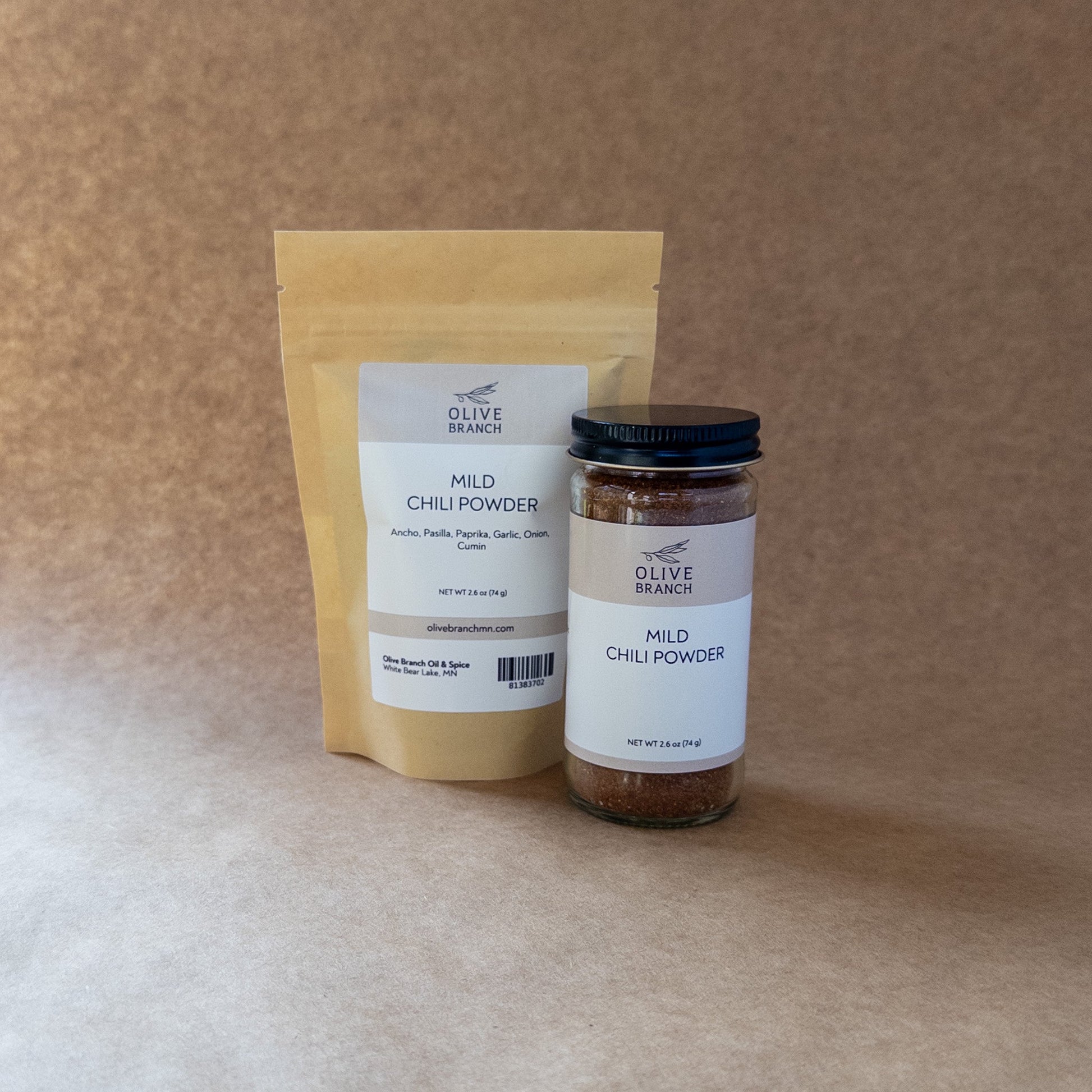 Mild chili powder blend from Olive Branch Oil & Spice in a spice jar, showing vibrant red chili flakes and powder.