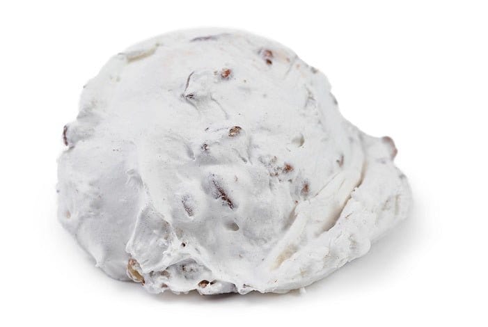 Individual pecan divinity treat from Millican Pecan, showcasing a glazed, nut-filled confection on a white background.