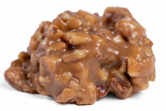 Individual Chewy Pecan Pralines by Millican Pecan, showcasing glossy caramel-coated pecan treats in a close-up shot.